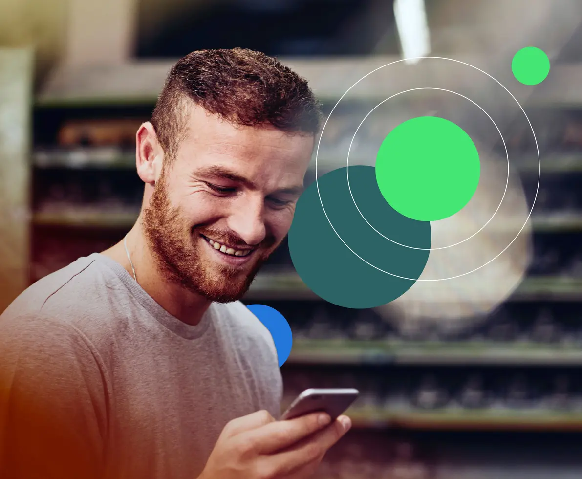 man smiling looking at phone