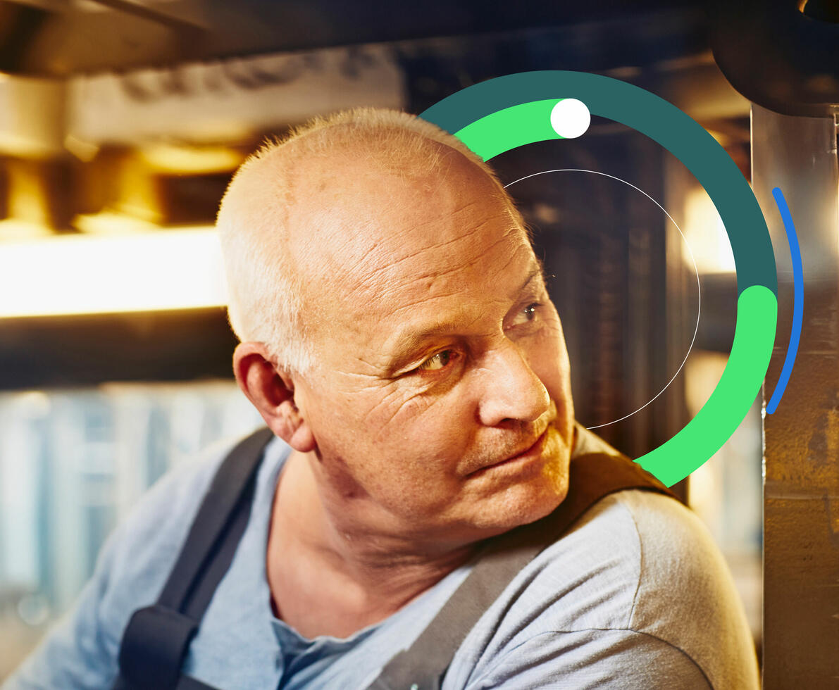 an image of an older male looking behind him while sitting in a forklift