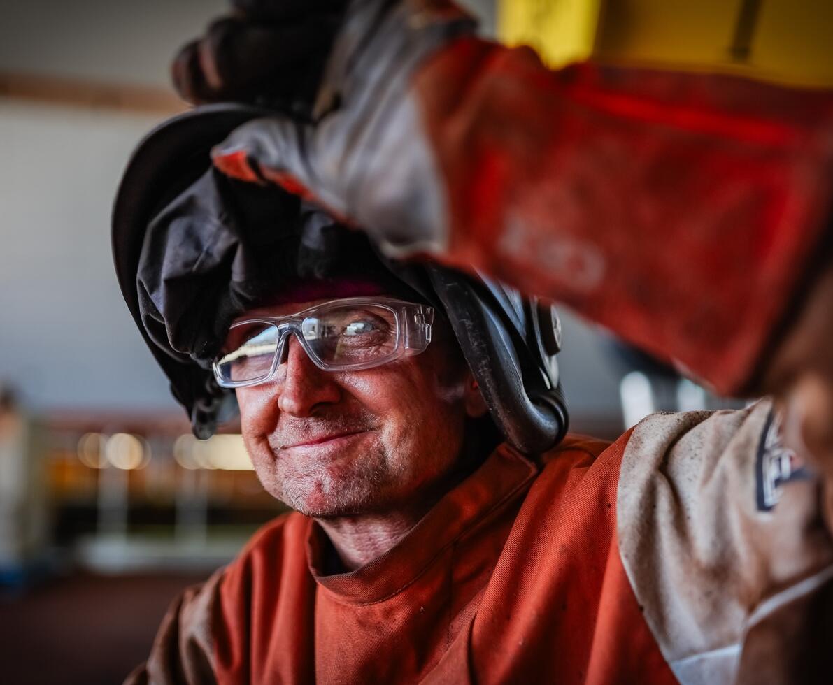 an image of a smiling man wearing protective gear