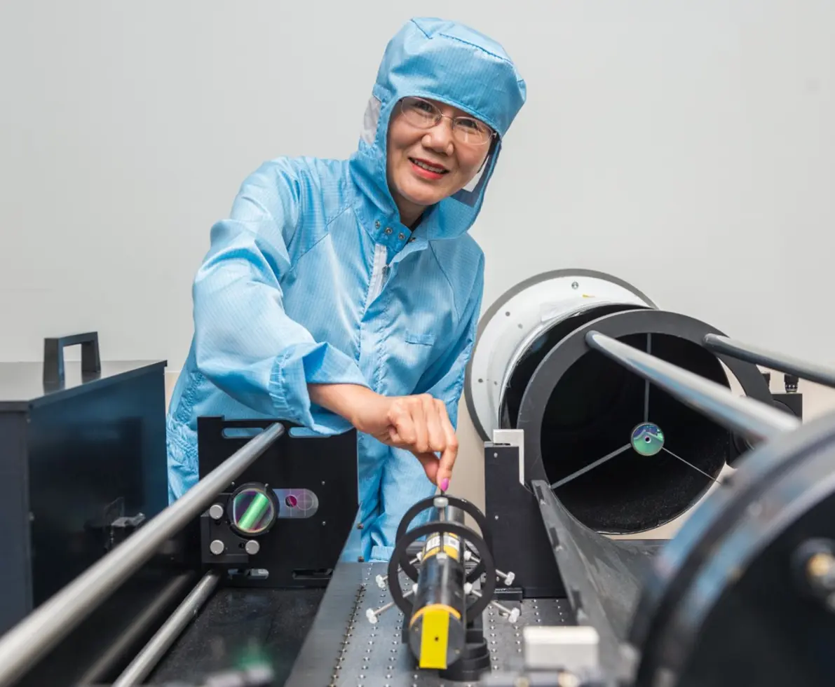 an image of a woman wearing a protective suit smiling 