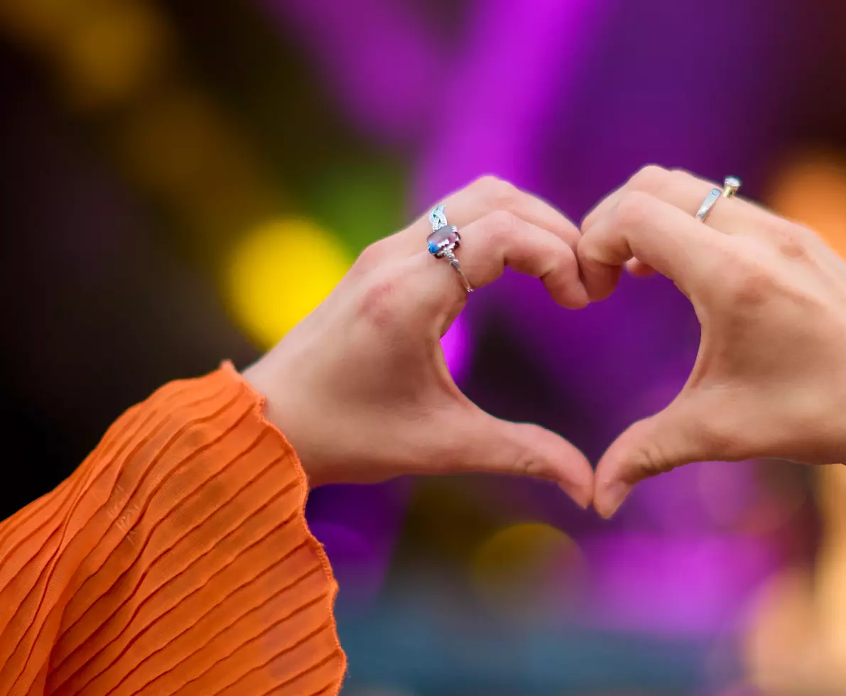 Close up of person making heart shaped hand gesture 