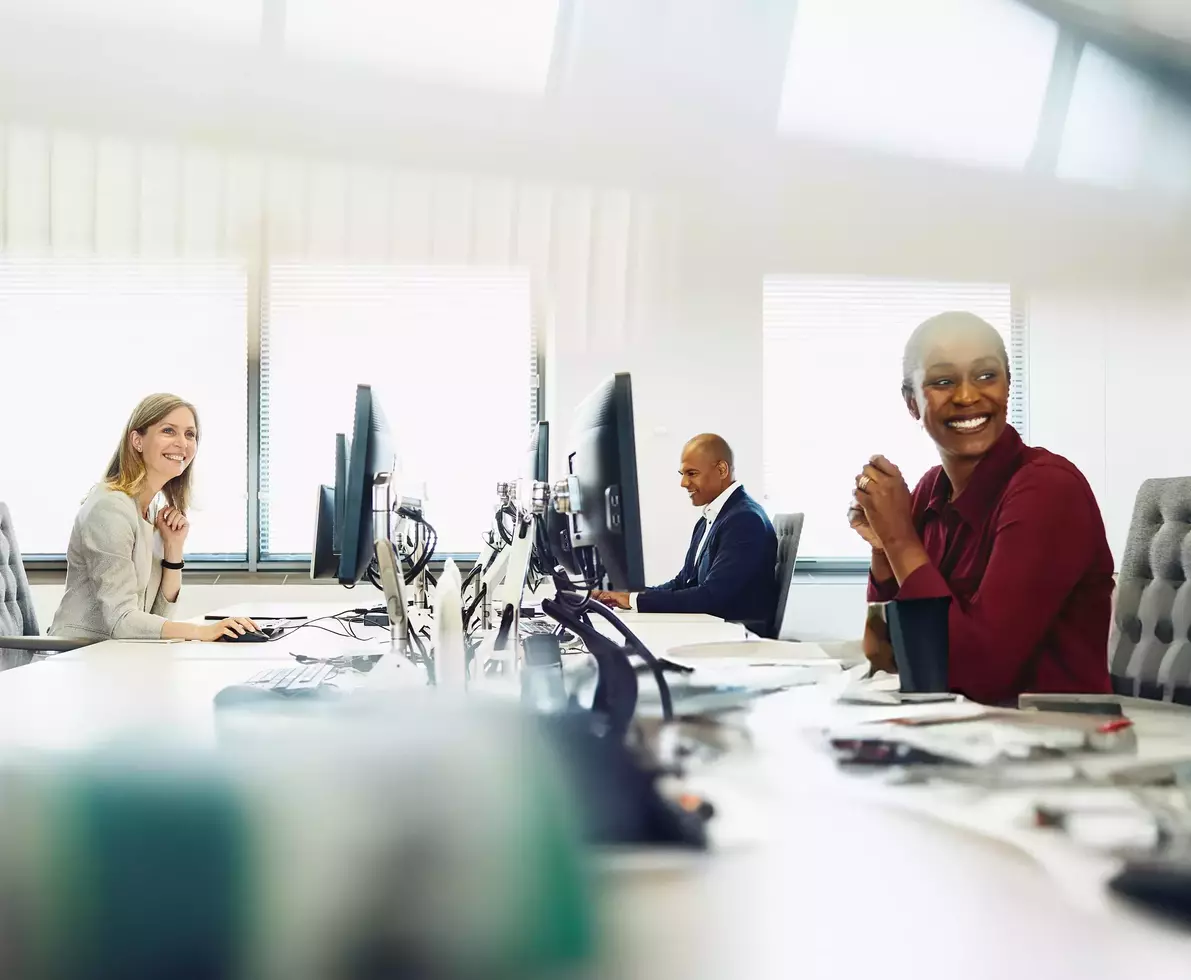 Two female and a male are working on their desk