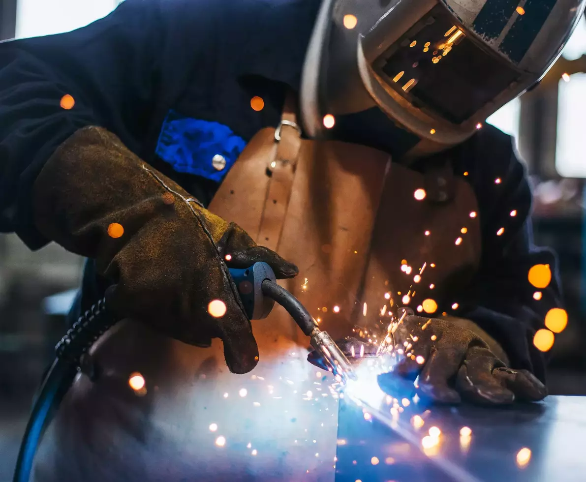 A person welding metal.