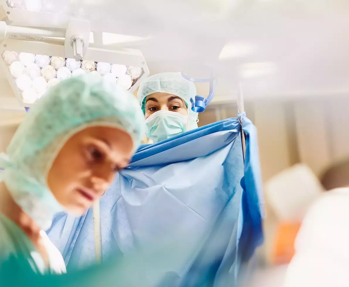 healthcare professionals working on a patient in an operating theatre