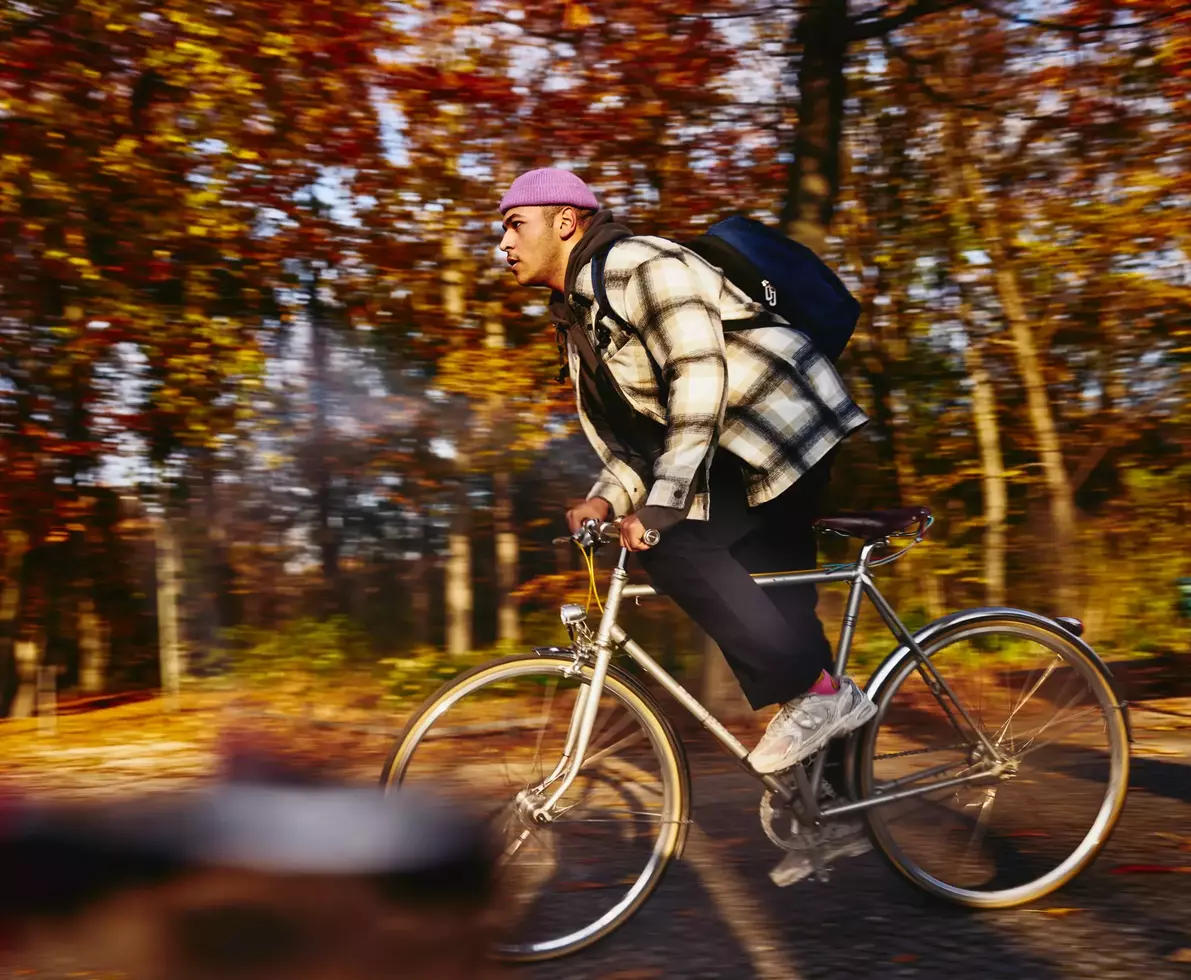 Cycling male, autumn trees on the background.
