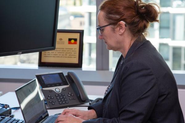 A photo of a woman working on her desk