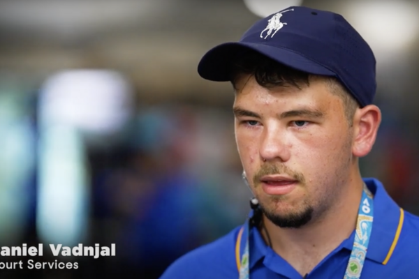 boy with navy blue cap and bright blue polo shirt