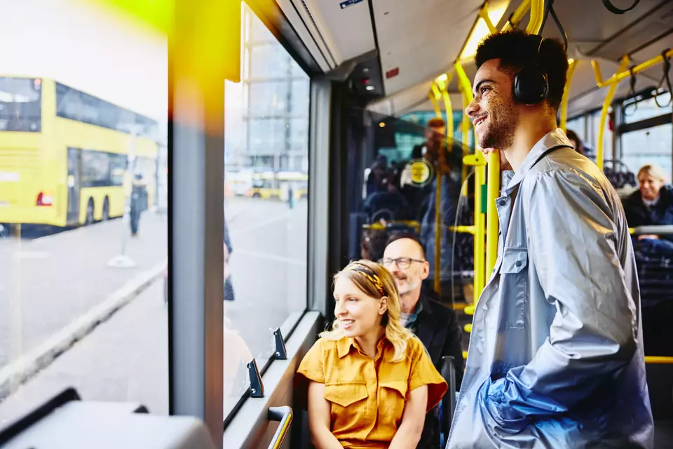 smiling people looking outside from the bus
