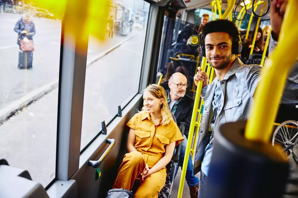 smiling people looking outside from the bus