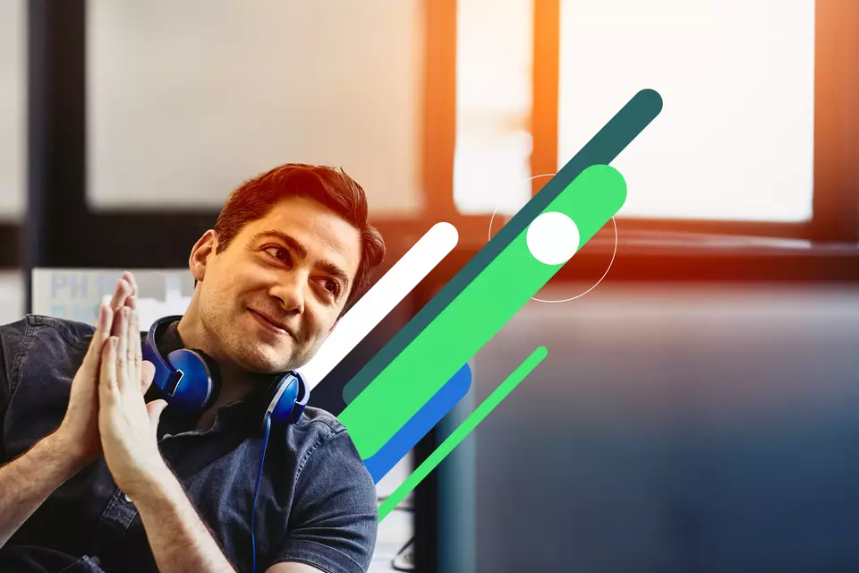 an image of a man smiling while wearing a headset on his neck