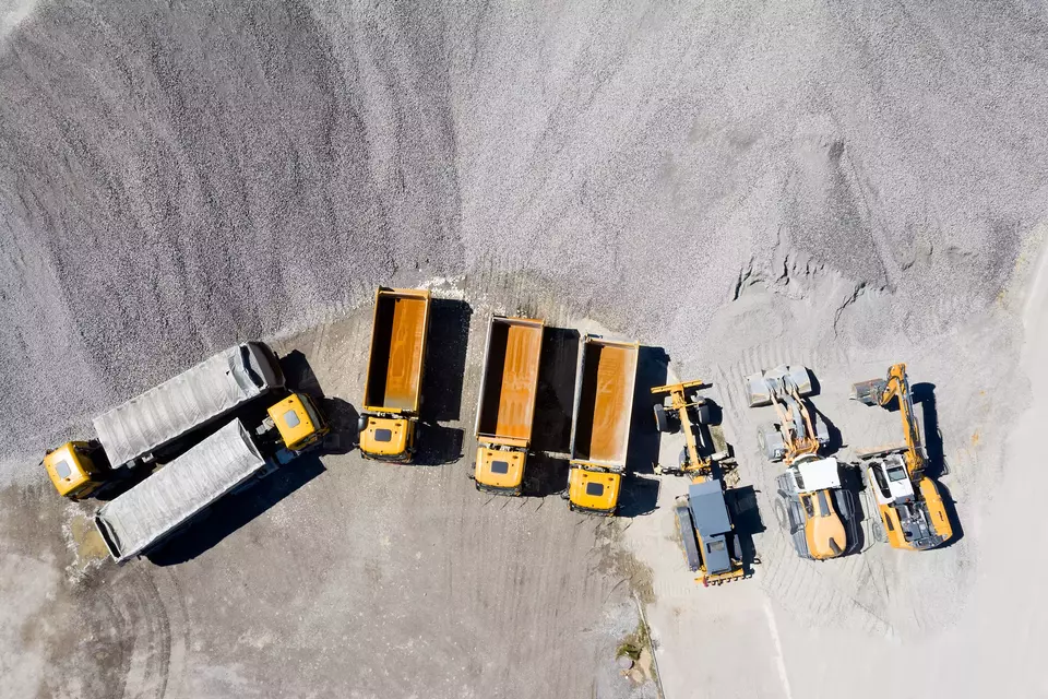 Aerial view of dump trucks and construction machines.