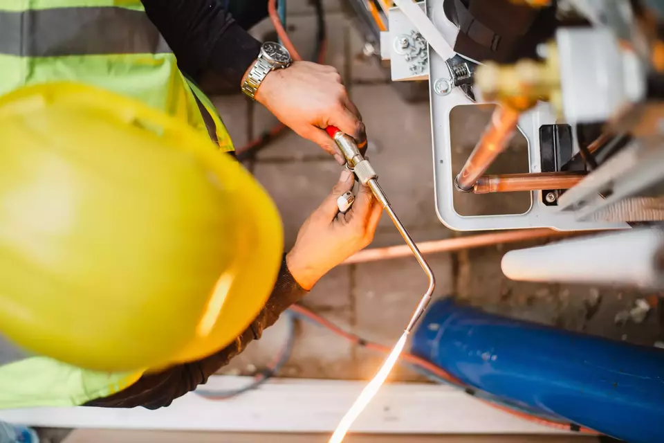 Air conditioner technician services outdoor AC unit and the Gas Generator