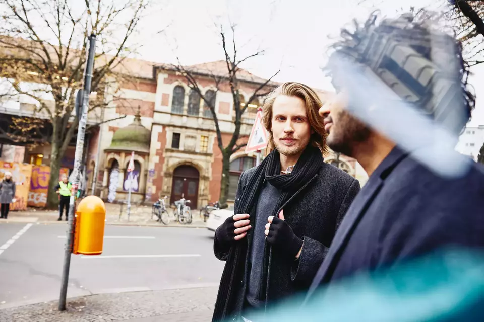 Two men walking on the streets.
