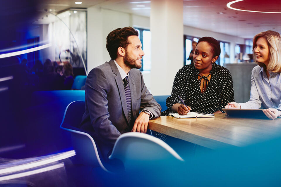 A man and two women having a discussion